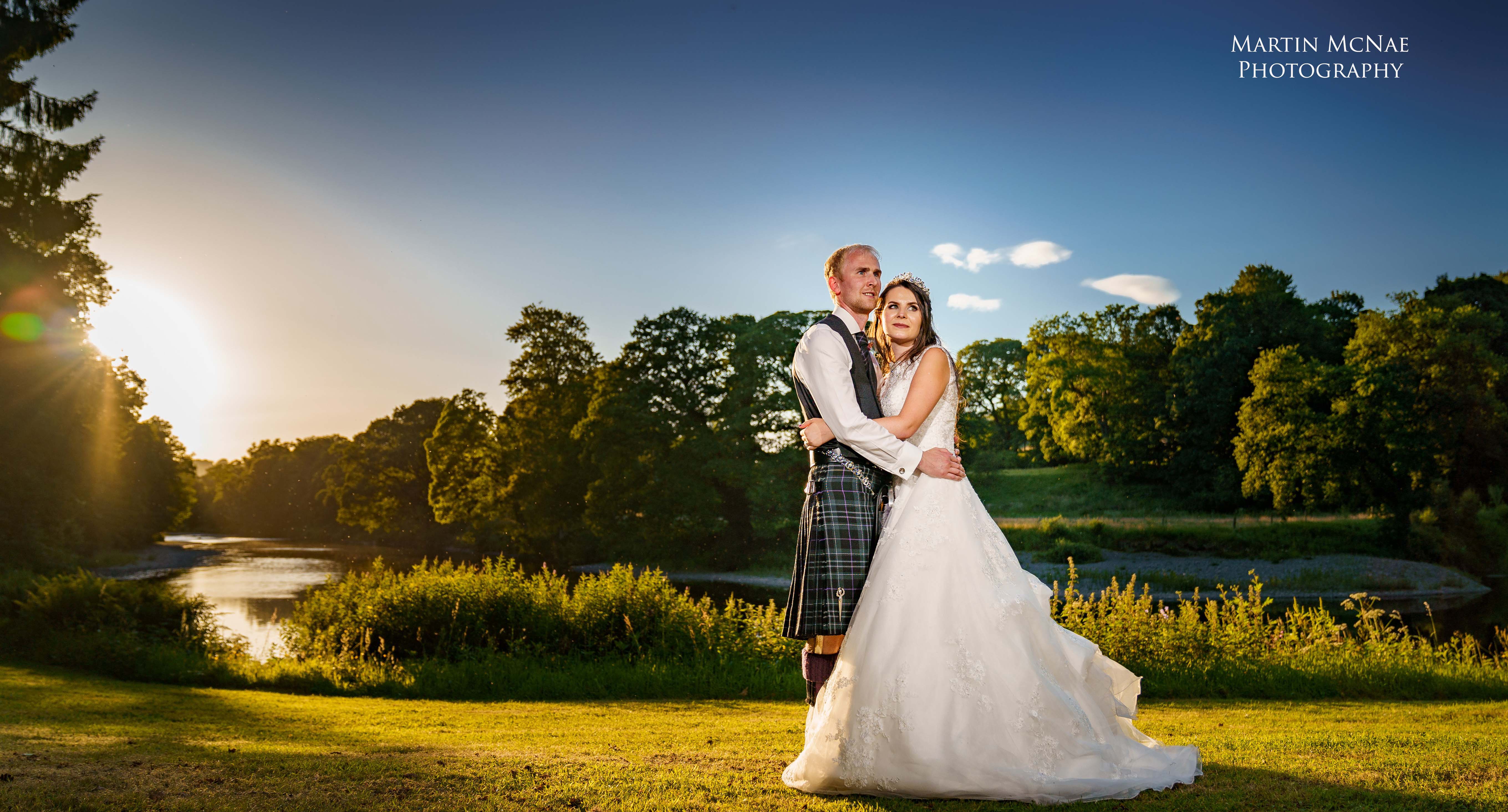 Wedding couple with sunset over River Nith